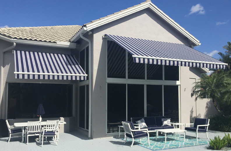 Grey house with awnings over the windows