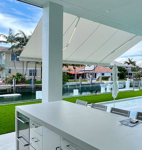 A retractable awning with a florida canal in the background